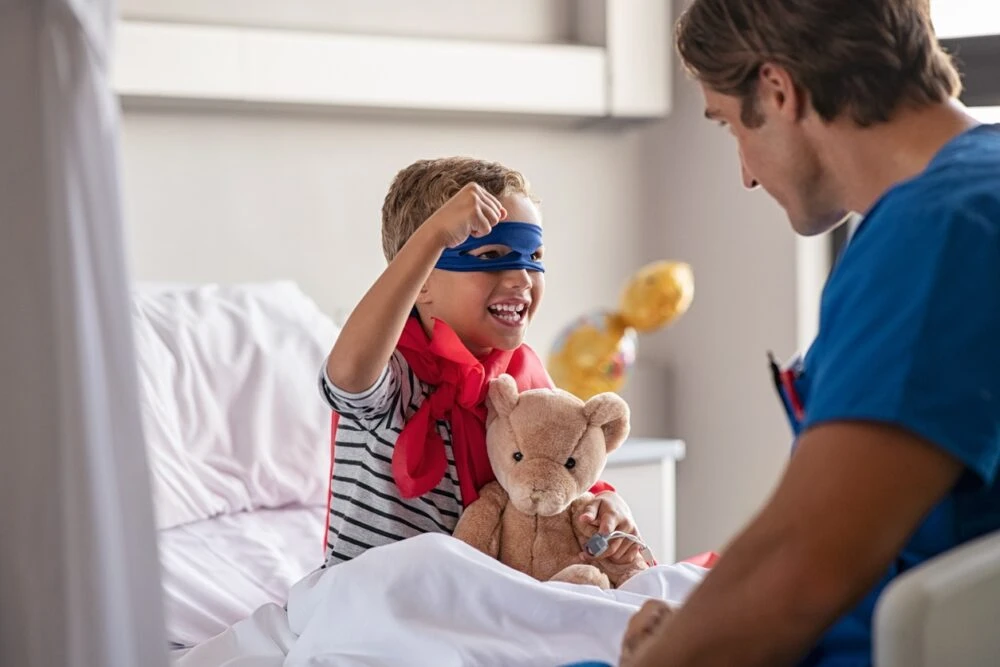 Little cute boy dressed like superhero with nurse